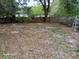 Large backyard featuring a lawn and a wooden fence at 2212 Ne 11 Ct, Ocala, FL 34470