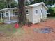 View of the backyard with trees and a tidy well kept lawn at 2212 Ne 11 Ct, Ocala, FL 34470