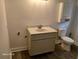 Bathroom featuring a sink with white cabinets, and a toilet at 2212 Ne 11 Ct, Ocala, FL 34470