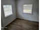 This cozy bedroom is filled with natural light from two large windows at 2212 Ne 11 Ct, Ocala, FL 34470