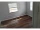 Bright bedroom featuring hardwood flooring and natural light from two windows at 2212 Ne 11 Ct, Ocala, FL 34470