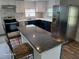 Modern kitchen with stainless steel appliances, an island, and updated countertops at 2212 Ne 11 Ct, Ocala, FL 34470