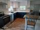 Updated kitchen with stainless steel appliances, stone backsplash, and stylish cabinetry at 2212 Ne 11 Ct, Ocala, FL 34470