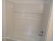 Clean and modern shower features white tiles with built-in shelving at 2212 Ne 11 Ct, Ocala, FL 34470