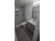 Bathroom featuring walk-in shower with marble tile and dark grey tiled floors at 312 Dorothy Ave, Daytona Beach, FL 32117