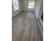 Bright living room featuring wood-style flooring and natural light from two large windows at 312 Dorothy Ave, Daytona Beach, FL 32117