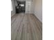Open living room featuring wood-style flooring, natural light and access to a modern kitchen and bathroom at 312 Dorothy Ave, Daytona Beach, FL 32117