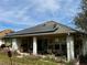 View of back porch with patio, slider, and solar panels on roof at 11928 Se 91St Cir, Summerfield, FL 34491