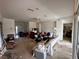 Spacious living room with carpeted floors, ceiling fan, and an open layout to entry at 11928 Se 91St Cir, Summerfield, FL 34491
