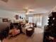 Cluttered main bedroom with carpeted floors, ceiling fan, curtains, and standard closet at 11928 Se 91St Cir, Summerfield, FL 34491