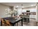 Open dining room and kitchen area with seating for four, and stainless steel appliances at 1629 Sage Ave, Haines City, FL 33844