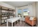 Bright home office space with desk, chair, shelving and large windows offering plenty of light at 1629 Sage Ave, Haines City, FL 33844