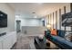 Open-concept living room with a comfortable sofa, movie decor, and cozy lighting at 1629 Sage Ave, Haines City, FL 33844