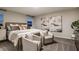 Bright main bedroom featuring a comfortable bed, accent chairs, and neutral decor at 1629 Sage Ave, Haines City, FL 33844