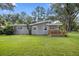 A beautiful landscaped backyard showcasing mature tree and lush lawn at 208 Se 32Nd Ave, Ocala, FL 34471