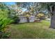 Landscaped backyard of this lovely single-story home, showcasing mature trees and privacy at 208 Se 32Nd Ave, Ocala, FL 34471