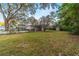 Spacious backyard with lush green grass and mature trees at 208 Se 32Nd Ave, Ocala, FL 34471