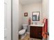 Half bath features a wooden vanity and tile floor at 208 Se 32Nd Ave, Ocala, FL 34471