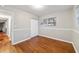 Bedroom featuring wood floors, base molding, and natural light from a window at 208 Se 32Nd Ave, Ocala, FL 34471