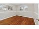 Bedroom with hardwood floors, base molding, and natural light from two windows at 208 Se 32Nd Ave, Ocala, FL 34471