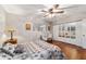 Bedroom with hardwood floors, ceiling fan, natural light, and a mirrored closet at 208 Se 32Nd Ave, Ocala, FL 34471
