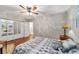 Bedroom featuring hardwood floors, a ceiling fan, and a mirrored closet, with attached bathroom visible at 208 Se 32Nd Ave, Ocala, FL 34471