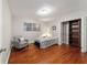 Cozy bedroom with wood floors, light walls, closet, and one window letting in ample light at 208 Se 32Nd Ave, Ocala, FL 34471