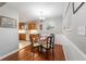 This cozy dining area has hardwood floors, wainscotting, a chandelier and a view to the kitchen at 208 Se 32Nd Ave, Ocala, FL 34471