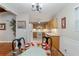 Dining room overlooking the kitchen, with hardwood floors, and a glass table set for four at 208 Se 32Nd Ave, Ocala, FL 34471