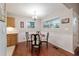 This dining area features hardwood floors, wainscotting, bright lighting, and a kitchen view at 208 Se 32Nd Ave, Ocala, FL 34471