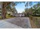 Charming single-story home with a large driveway and mature trees at 208 Se 32Nd Ave, Ocala, FL 34471