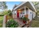 Quaint exterior with a inviting front porch, seating and a red door, perfect for enjoying the outdoors at 208 Se 32Nd Ave, Ocala, FL 34471