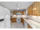 Kitchen with white appliances, wood cabinets, and stone countertops at 208 Se 32Nd Ave, Ocala, FL 34471