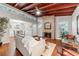 Spacious living room boasts hardwood floors, brick fireplace, vaulted ceilings and an adjacent dining area at 208 Se 32Nd Ave, Ocala, FL 34471