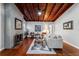 Inviting living room features a brick fireplace, wooden ceilings, hardwood floors and a neutral color palette at 208 Se 32Nd Ave, Ocala, FL 34471