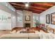 Bright living room featuring wood-clad vaulted ceilings, brick fireplace, hardwood floors and lots of natural light at 208 Se 32Nd Ave, Ocala, FL 34471
