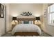 Comfortable bedroom with a wooden headboard, bedside lamps, and decorative wall art at 5048 Barnet Dr, Davenport, FL 33837