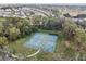 Aerial view of community tennis and pickleball courts surrounded by trees and greenery at 1839 Via Lago Dr, Lakeland, FL 33810