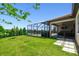 Well-maintained backyard with lush green lawn, screened lanai, and views of the lake at 1839 Via Lago Dr, Lakeland, FL 33810