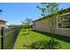 Lush backyard with a well-maintained lawn and black metal fencing for privacy at 1839 Via Lago Dr, Lakeland, FL 33810