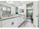 The spacious bathroom features dual sinks with granite countertop and vanity with white cabinets at 1839 Via Lago Dr, Lakeland, FL 33810