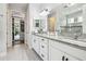 Beautiful bathroom featuring double sinks, granite countertop, and walk-in shower with glass door at 1839 Via Lago Dr, Lakeland, FL 33810