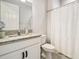 The bathroom features a granite countertop, sink, a mirror, and a toilet at 1839 Via Lago Dr, Lakeland, FL 33810