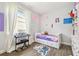 Bright bedroom featuring a window, keyboard, art, and ample space for activities at 1839 Via Lago Dr, Lakeland, FL 33810