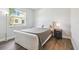 Well-lit bedroom showcasing wood floors and a comfortable bed by a bright window at 1839 Via Lago Dr, Lakeland, FL 33810