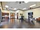 Inviting community room featuring a kitchenette, fireplace, TV, seating, and elegant dark wood-look floors at 1839 Via Lago Dr, Lakeland, FL 33810