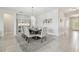 Dining room with neutral walls, tile floors, a modern chandelier, and a dining table set for six at 1839 Via Lago Dr, Lakeland, FL 33810