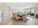 Dining area with a modern light fixture and a view of the kitchen and outdoor living space at 1839 Via Lago Dr, Lakeland, FL 33810