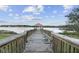 Wooden dock stretching out onto a lake with a covered gazebo at the end at 1839 Via Lago Dr, Lakeland, FL 33810
