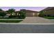 Charming single-story home with a brick driveway, tile roof, manicured landscaping, and a two-car garage at 1839 Via Lago Dr, Lakeland, FL 33810